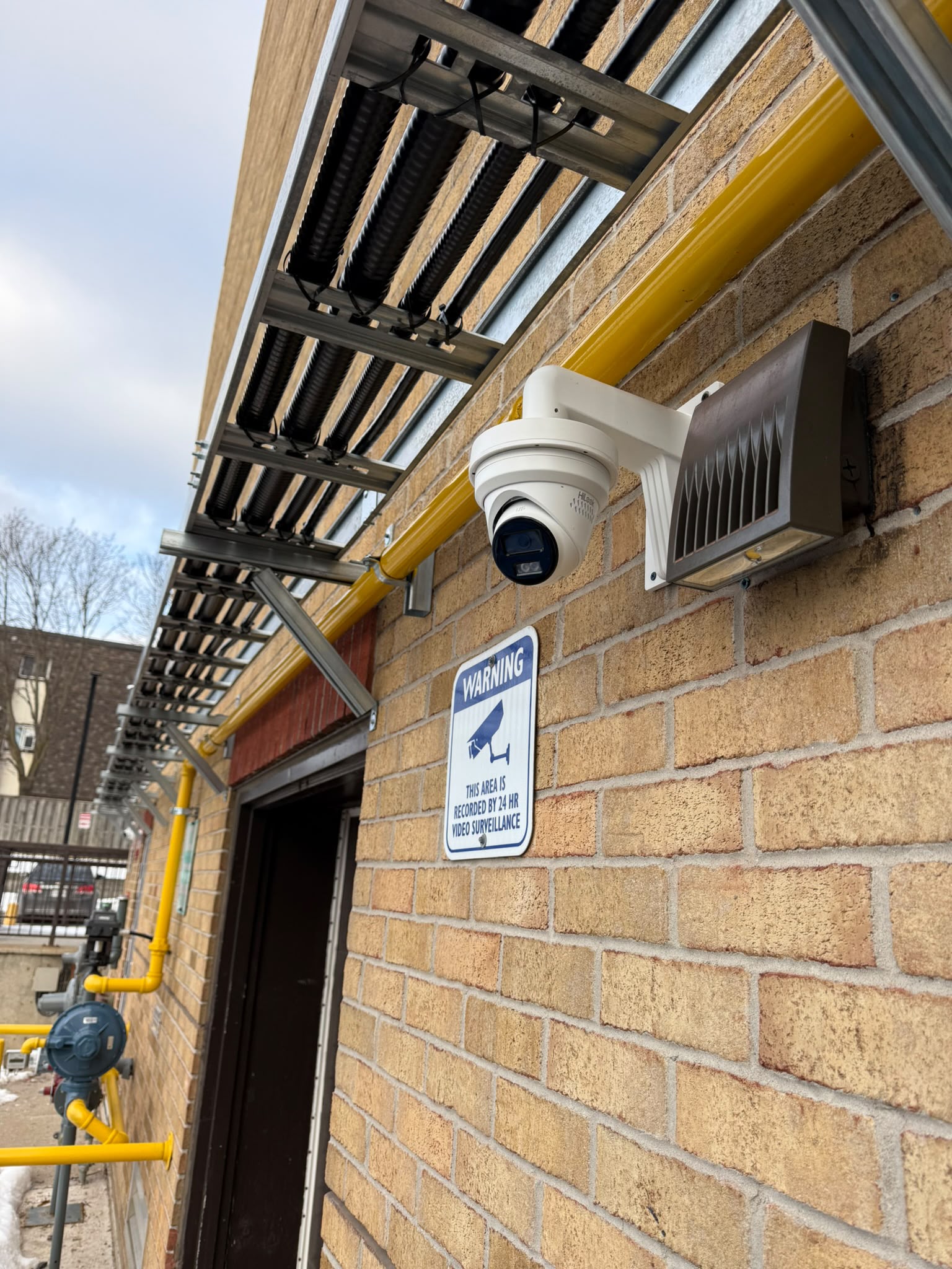 Dome security camera installed on commercial brick wall
